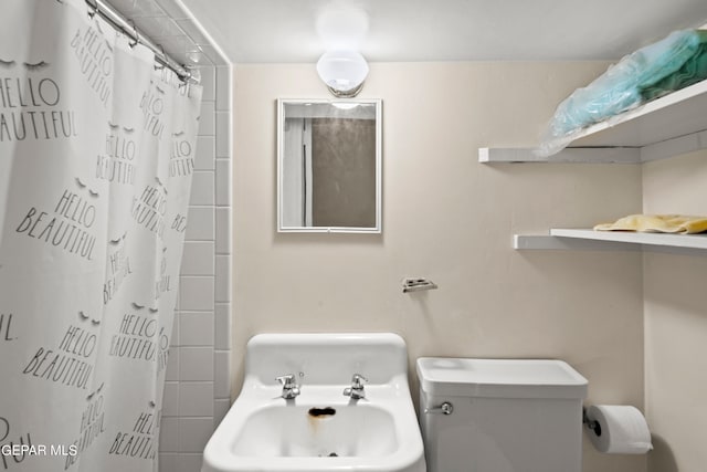 bathroom featuring walk in shower and toilet