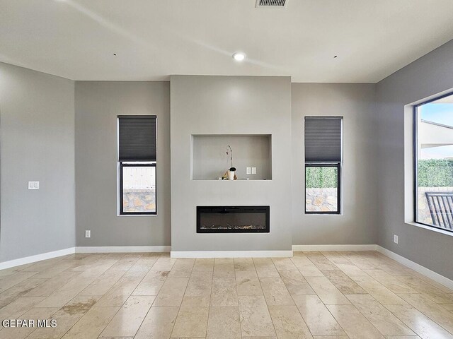 unfurnished living room with plenty of natural light