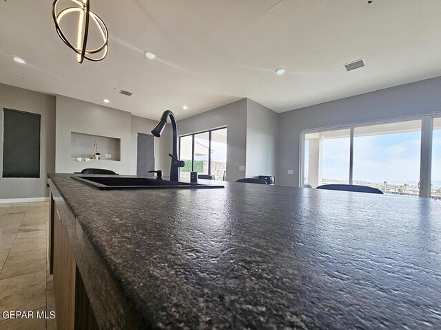 kitchen featuring a water view and sink