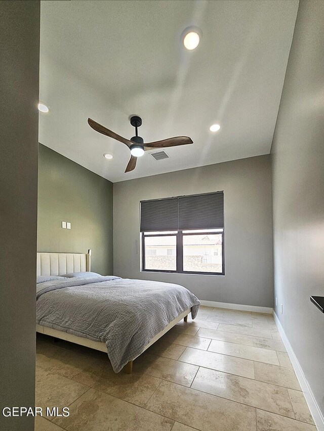 unfurnished bedroom featuring ceiling fan, radiator heating unit, and light tile patterned floors