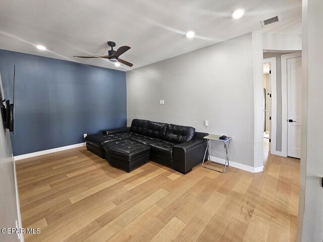 living room with ceiling fan and hardwood / wood-style flooring