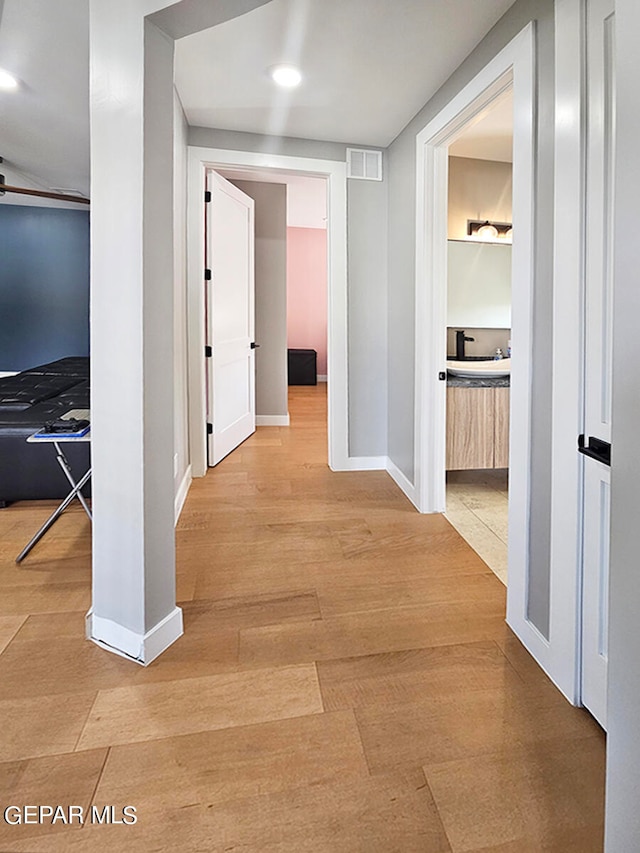 hallway with light wood-type flooring