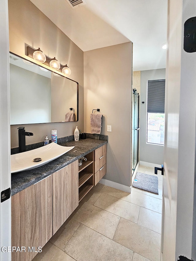 bathroom with vanity and an enclosed shower