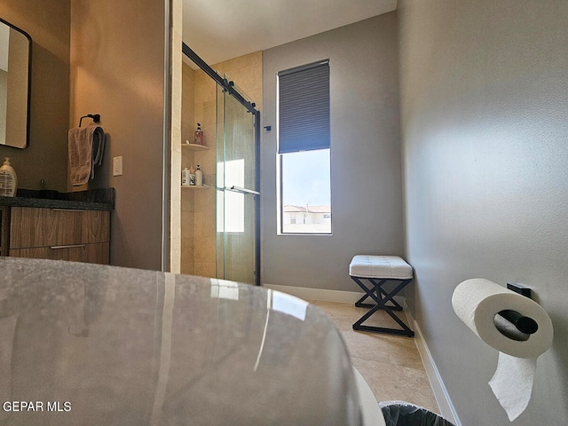 bathroom with vanity and a shower with door