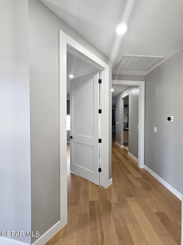 hall with light hardwood / wood-style floors