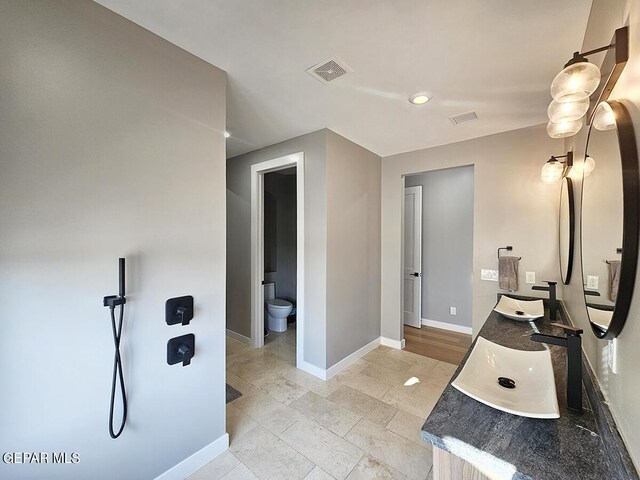 bathroom featuring tile patterned floors, vanity, and toilet