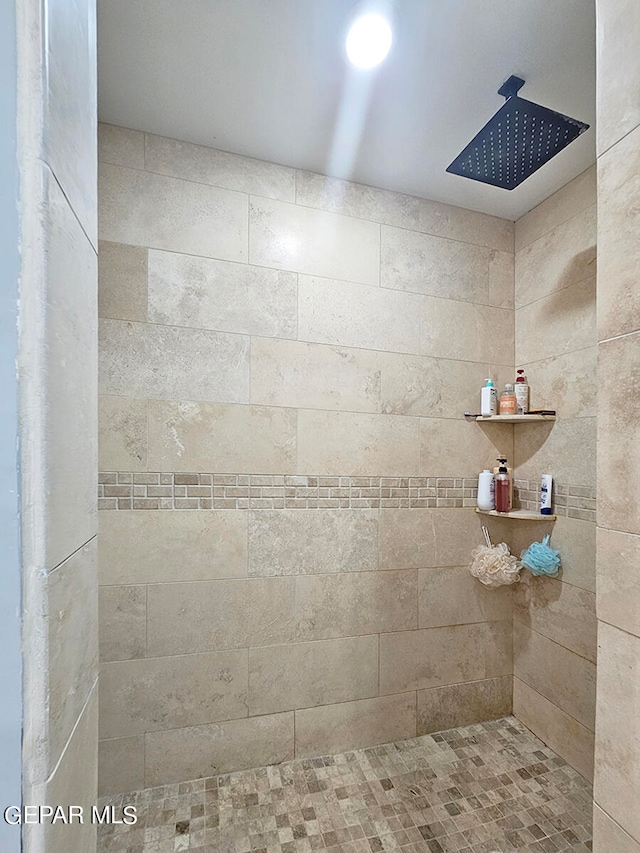 bathroom with tiled shower