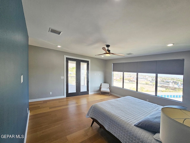 bedroom with multiple windows, french doors, access to exterior, and ceiling fan