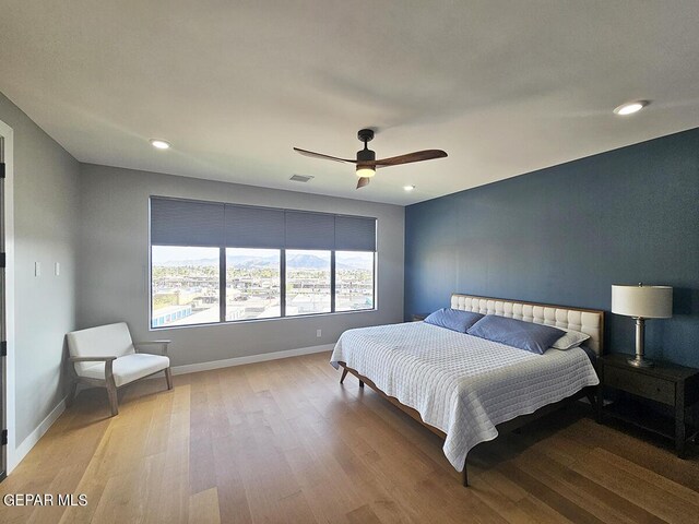 bedroom featuring light hardwood / wood-style floors and ceiling fan