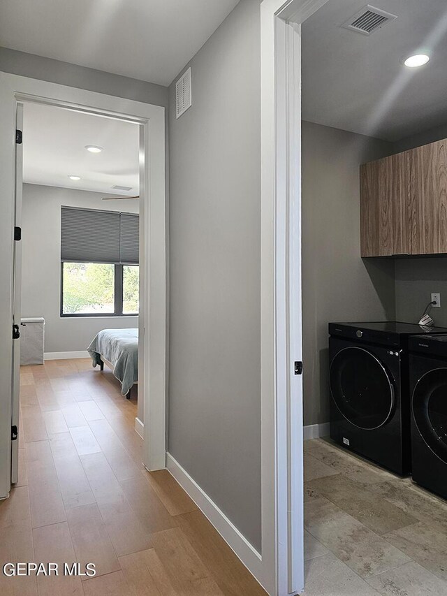 laundry room featuring cabinets and separate washer and dryer