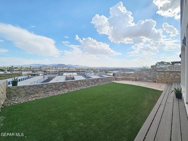 view of yard with a mountain view and a dock