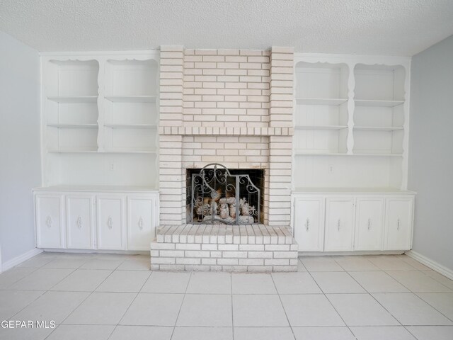 unfurnished living room with light tile patterned floors, a textured ceiling, and a fireplace