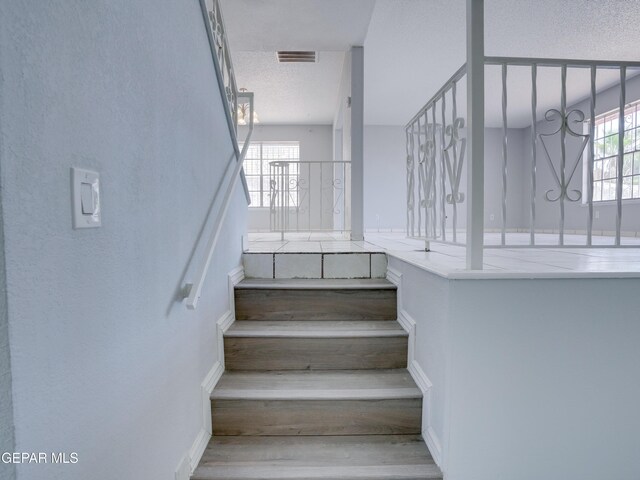 stairs featuring wood-type flooring