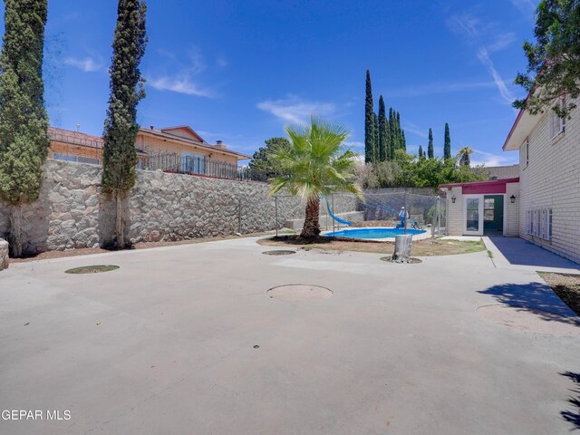 view of patio with a fenced in pool