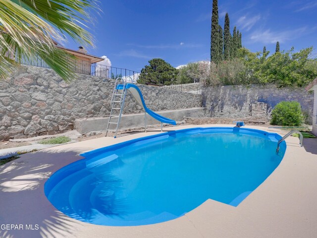 view of swimming pool featuring a water slide