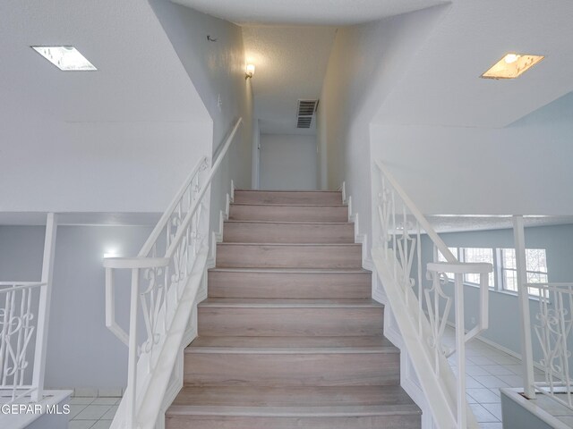 stairs with tile patterned floors