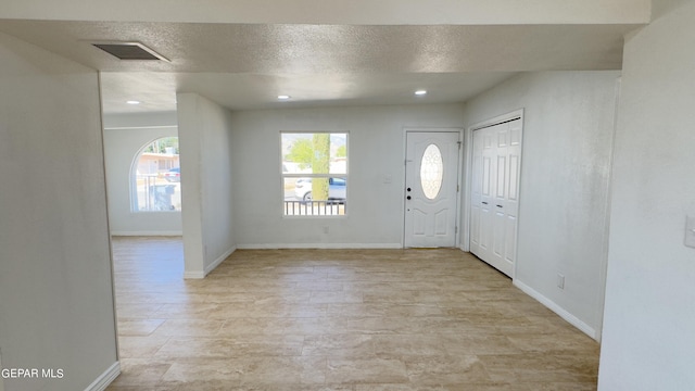 foyer featuring a textured ceiling