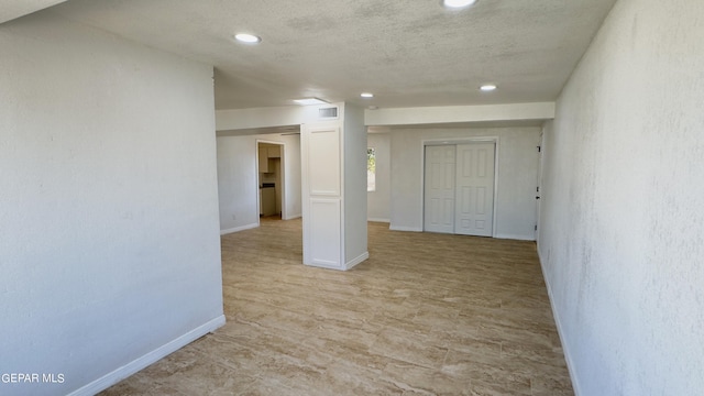 spare room featuring a textured ceiling