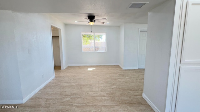 unfurnished room with ceiling fan