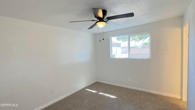 spare room with carpet and ceiling fan