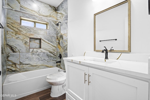 full bathroom with wood-type flooring, toilet, vanity, and tiled shower / bath