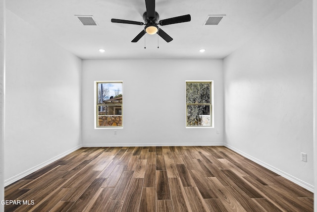 unfurnished room with dark wood-type flooring and ceiling fan