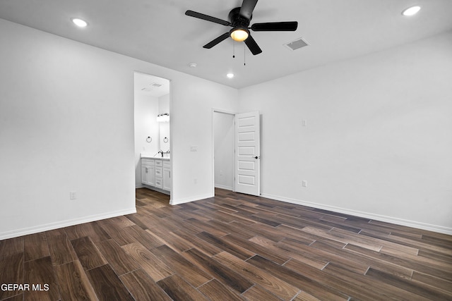 unfurnished bedroom featuring ceiling fan, ensuite bathroom, and sink