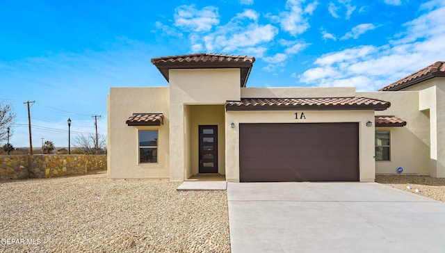 mediterranean / spanish house featuring a garage