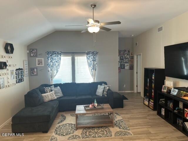 living room featuring ceiling fan, light wood-type flooring, and lofted ceiling