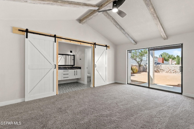 unfurnished bedroom with lofted ceiling with beams, access to exterior, carpet floors, a barn door, and ceiling fan