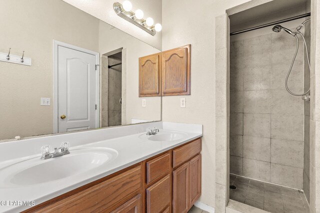 bathroom with vanity and tiled shower