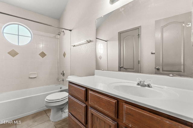 full bathroom with tiled shower / bath, vanity, tile patterned flooring, and toilet