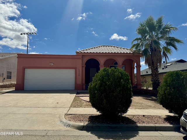 mediterranean / spanish house featuring a garage