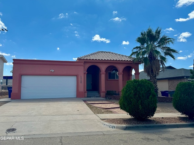 mediterranean / spanish-style house with a garage