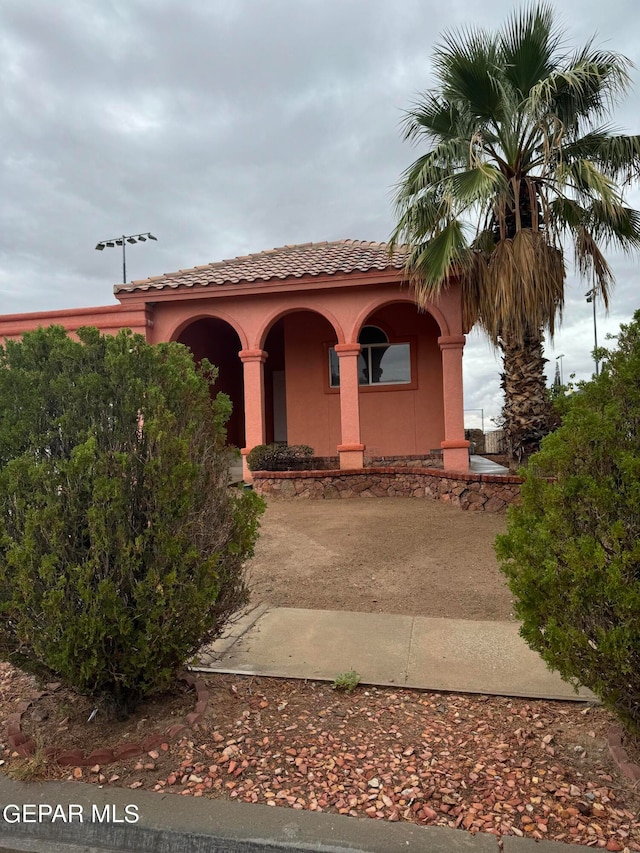 mediterranean / spanish-style house with a porch