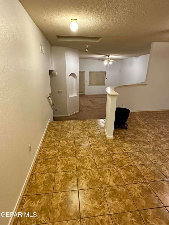 hall with a textured ceiling