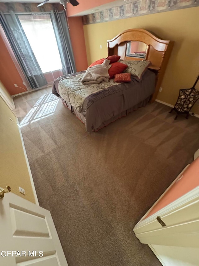 bedroom with ceiling fan and carpet flooring