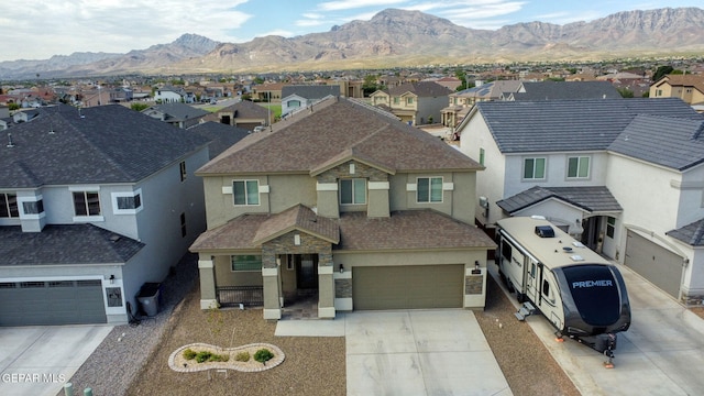 view of front of home with a mountain view and a garage