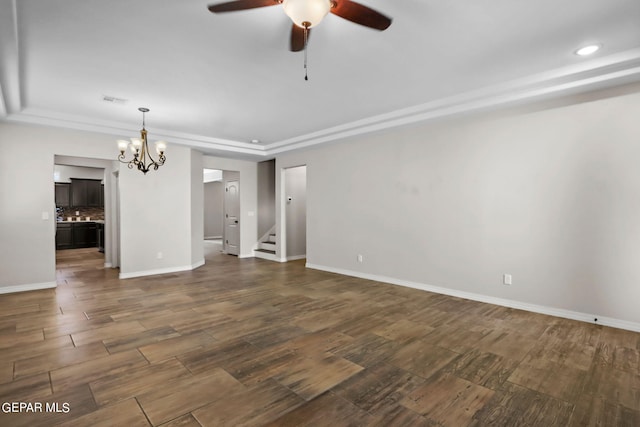 unfurnished room with ceiling fan with notable chandelier and dark hardwood / wood-style floors