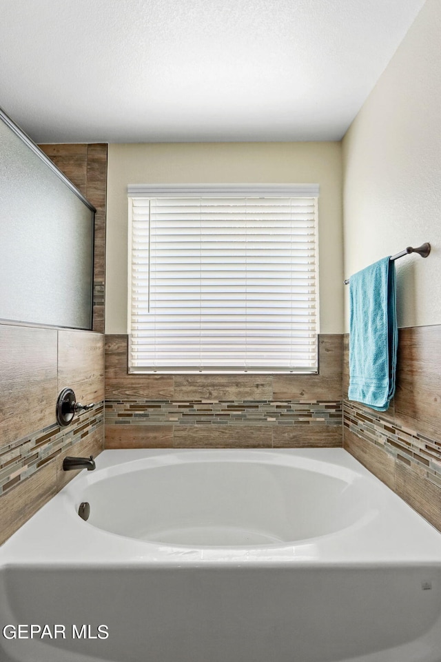 bathroom featuring a tub to relax in