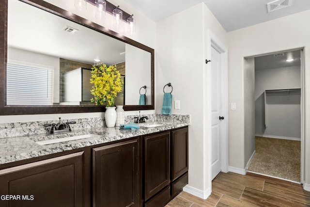 bathroom with hardwood / wood-style floors and vanity