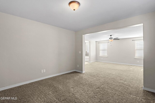 empty room featuring carpet flooring and ceiling fan