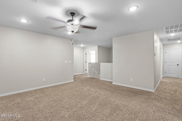 carpeted spare room with ceiling fan