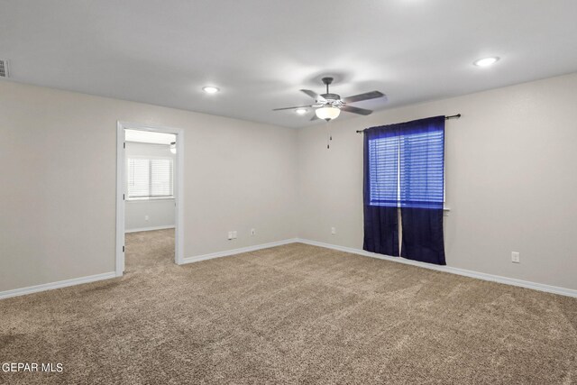 carpeted empty room featuring ceiling fan