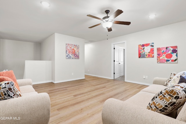 living room featuring ceiling fan and hardwood / wood-style floors