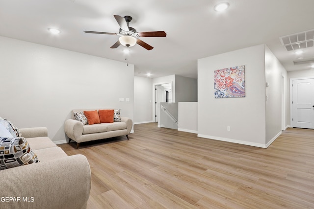 living room with ceiling fan and light hardwood / wood-style floors