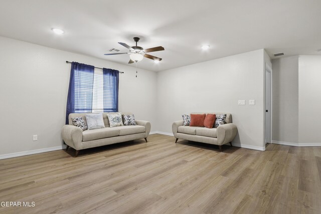 living room with ceiling fan and light hardwood / wood-style flooring