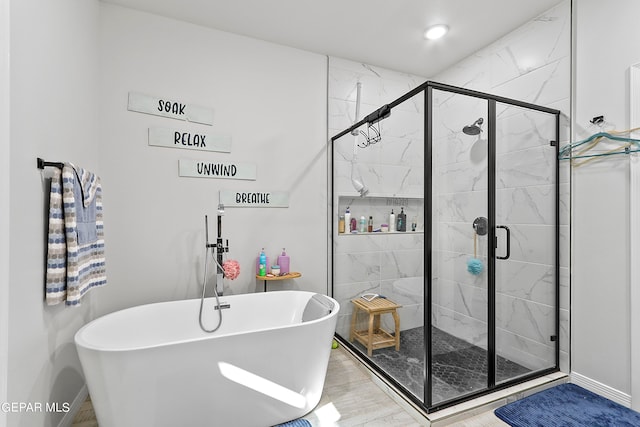 bathroom with independent shower and bath and wood-type flooring