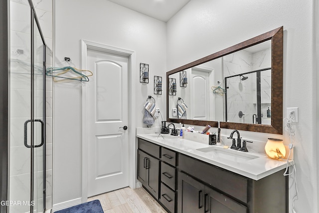 bathroom with vanity and a shower with door