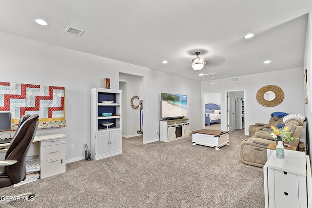 living room with ceiling fan and light colored carpet